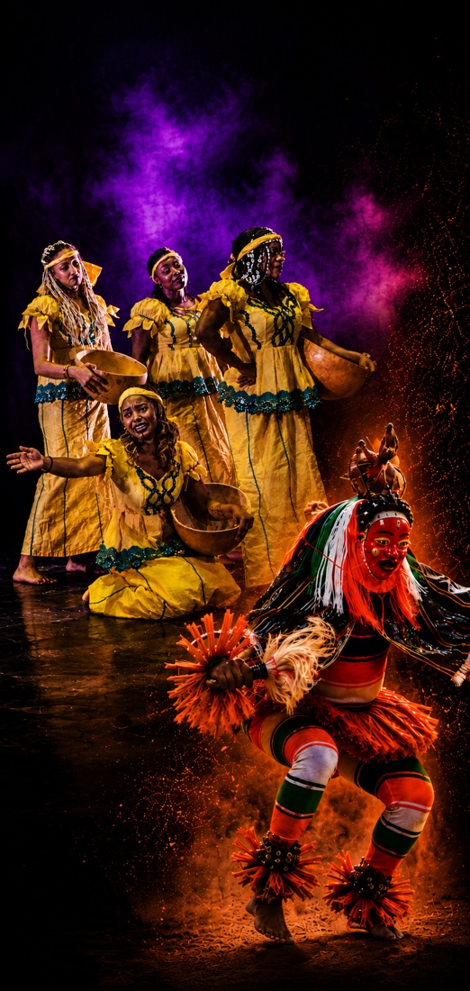 Danseurs en costumes traditionnels et danseur masqué sur scène